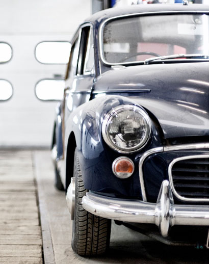 An antique Volkswagen beetle in a garage